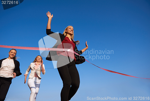 Image of business people running on racing track