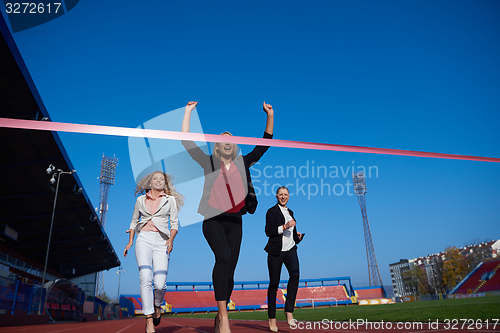 Image of business people running on racing track