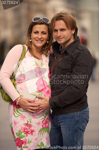 Image of young pregnant couple have fun and relax