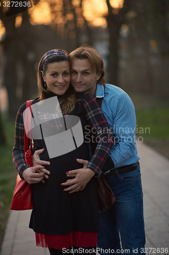 Image of young pregnant couple have fun and relax