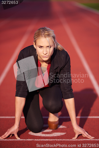 Image of business woman ready to sprint