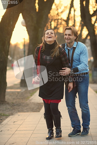 Image of young pregnant couple have fun and relax