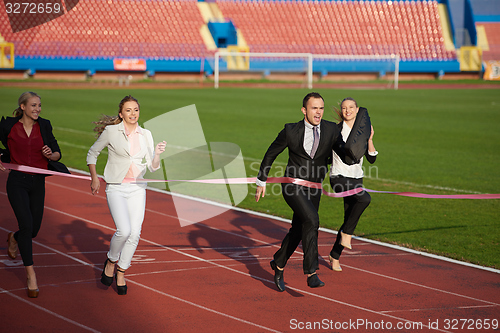 Image of business people running on racing track