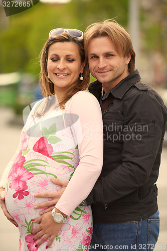 Image of young pregnant couple have fun and relax