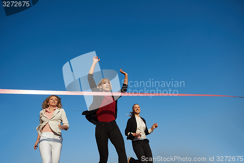 Image of business people running on racing track