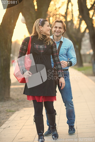 Image of young pregnant couple have fun and relax