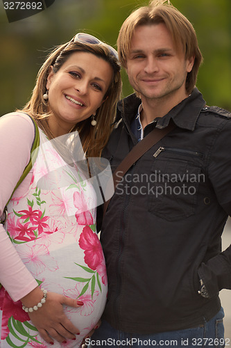 Image of young pregnant couple have fun and relax