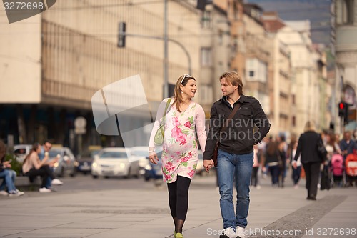 Image of young pregnant couple have fun and relax