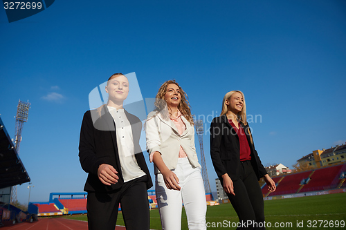 Image of business people running on racing track