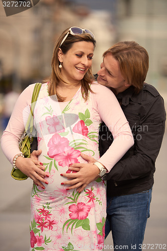 Image of young pregnant couple have fun and relax