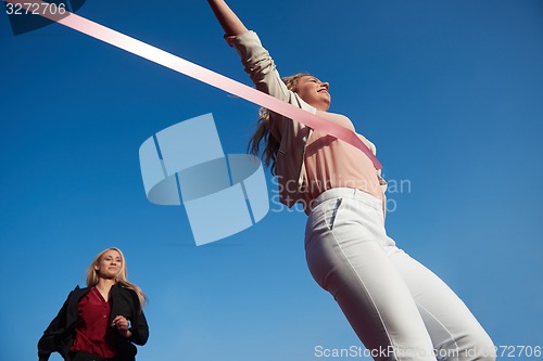 Image of business people running on racing track