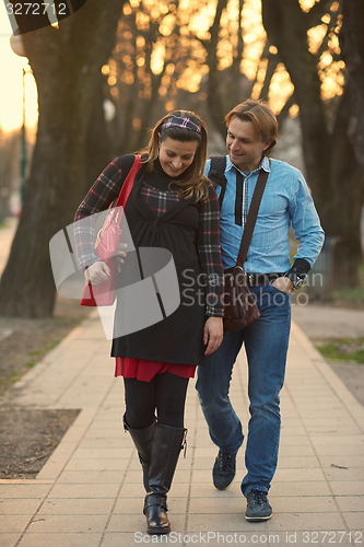 Image of young pregnant couple have fun and relax