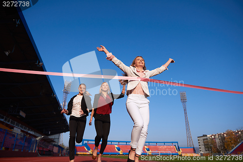 Image of business people running on racing track