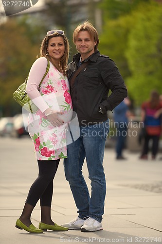 Image of young pregnant couple have fun and relax