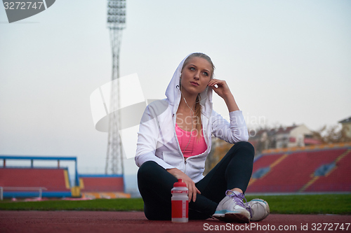 Image of sporty woman on athletic race track