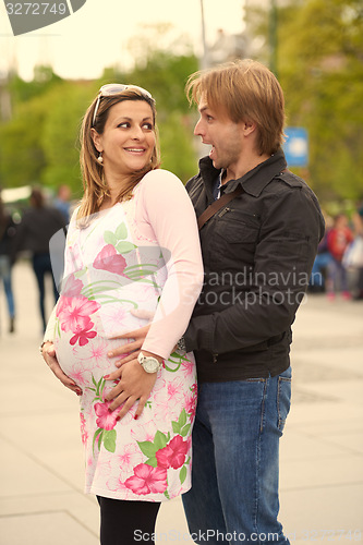 Image of young pregnant couple have fun and relax
