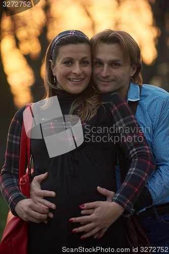 Image of young pregnant couple have fun and relax