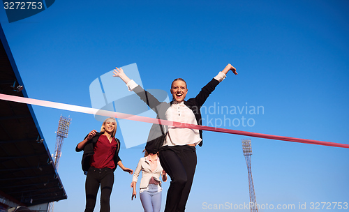 Image of business people running on racing track