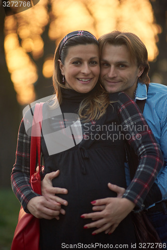 Image of young pregnant couple have fun and relax