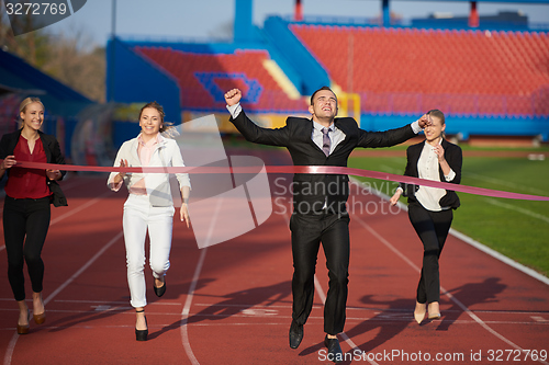 Image of business people running on racing track