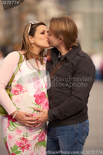 Image of young pregnant couple have fun and relax