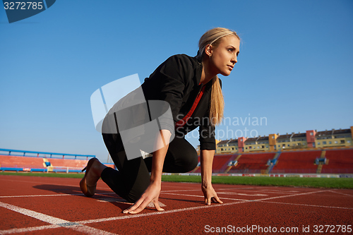 Image of business woman ready to sprint