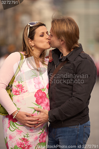 Image of young pregnant couple have fun and relax