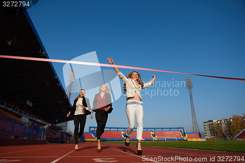 Image of business people running on racing track