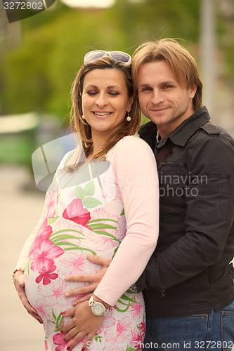 Image of young pregnant couple have fun and relax