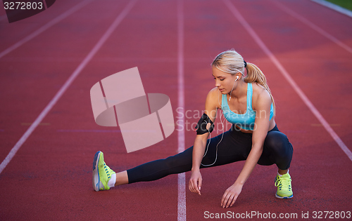 Image of sporty woman on athletic race track