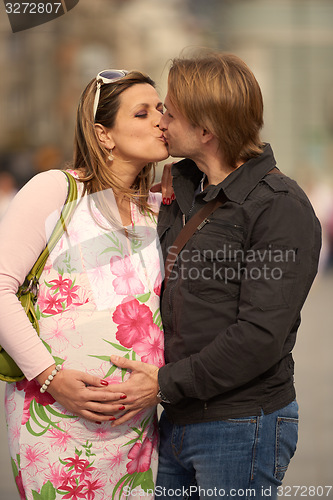 Image of young pregnant couple have fun and relax