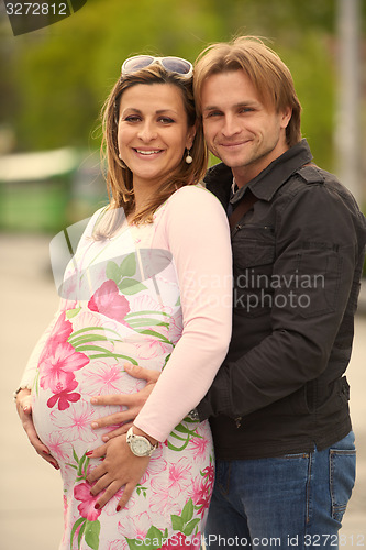 Image of young pregnant couple have fun and relax