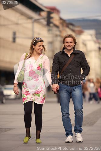 Image of young pregnant couple have fun and relax
