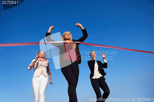 Image of business people running on racing track