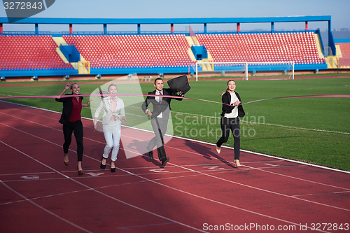 Image of business people running on racing track