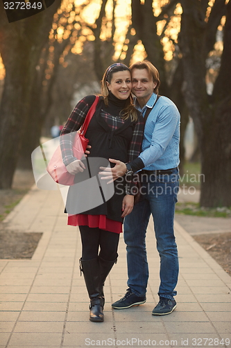 Image of young pregnant couple have fun and relax