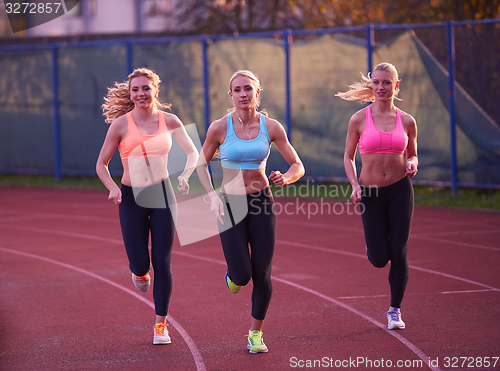 Image of athlete woman group  running on athletics race track