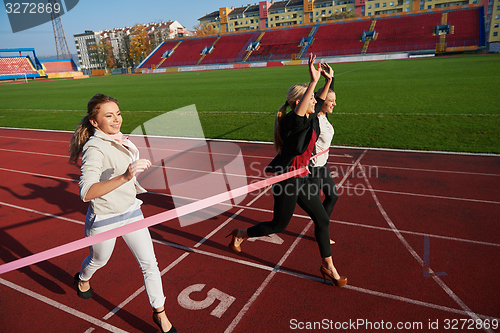 Image of business people running on racing track