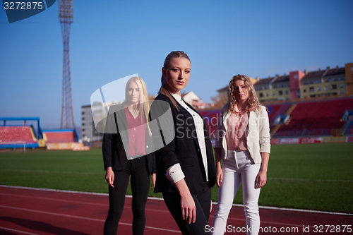 Image of business people running on racing track