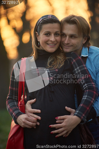 Image of young pregnant couple have fun and relax