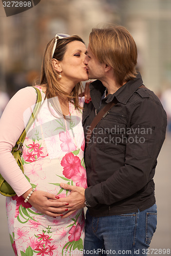 Image of young pregnant couple have fun and relax