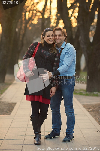 Image of young pregnant couple have fun and relax
