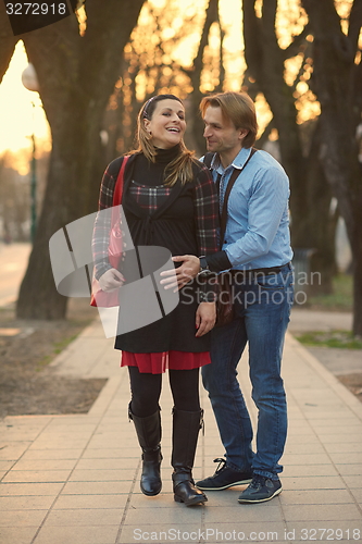 Image of young pregnant couple have fun and relax
