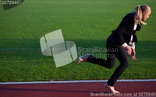 Image of business woman ready to sprint