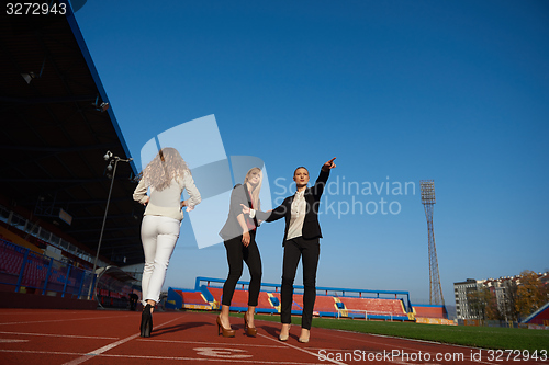 Image of business people running on racing track