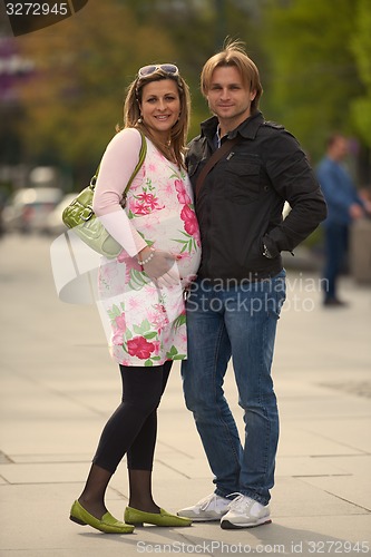 Image of young pregnant couple have fun and relax