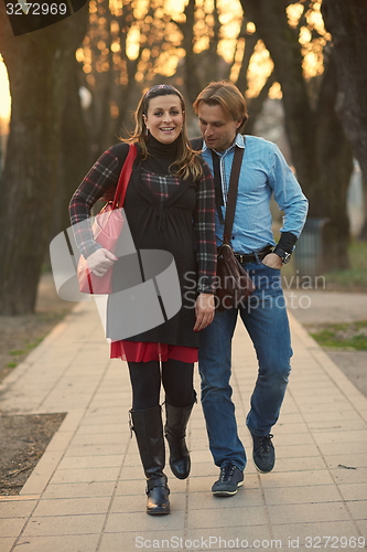 Image of young pregnant couple have fun and relax