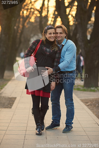 Image of young pregnant couple have fun and relax