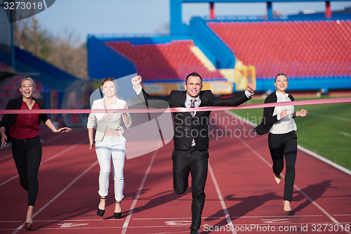 Image of business people running on racing track