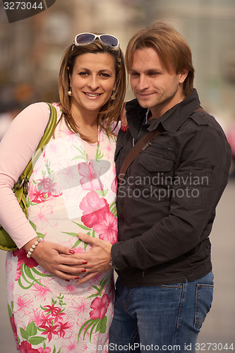 Image of young pregnant couple have fun and relax